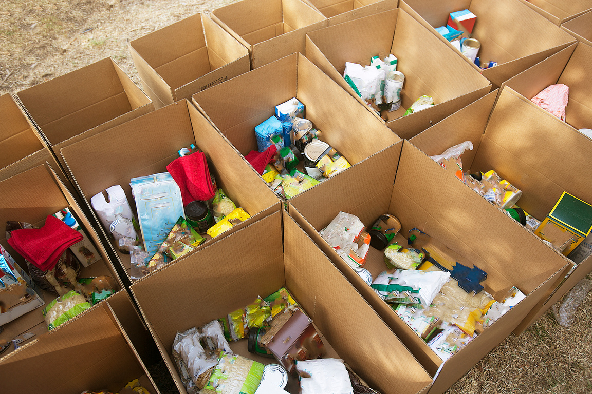 Cardboard boxes being filled with food donations